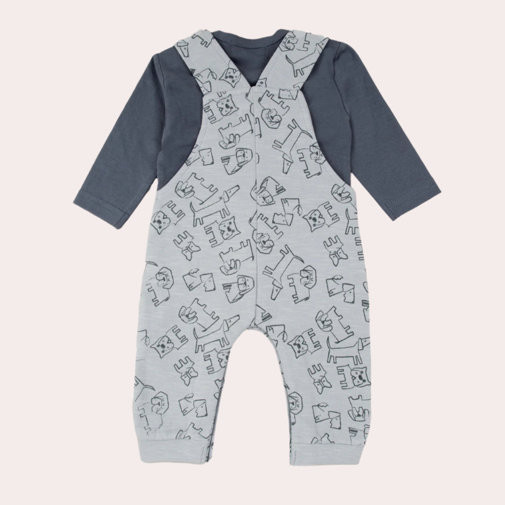 Baby overalls with dog pattern and navy blue sleeves on a grey background