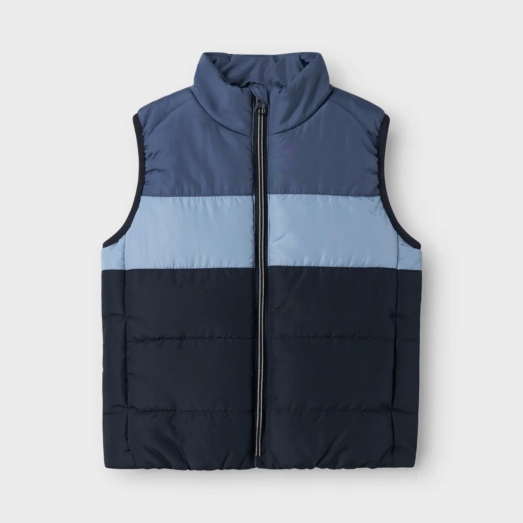 Two-tone blue puffer vest on a light grey background