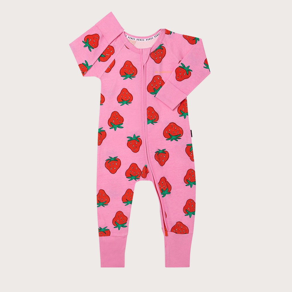 Pink baby onesie with strawberry pattern on a white background
