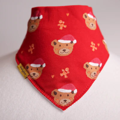 Red bandana bib with bear illustrations wearing Santa hats on a light  background