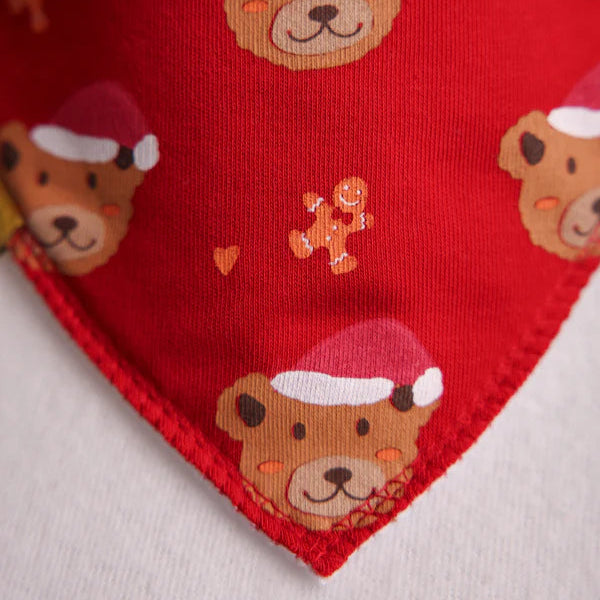 Red fabric with teddy bear and gingerbread man pattern on a white background