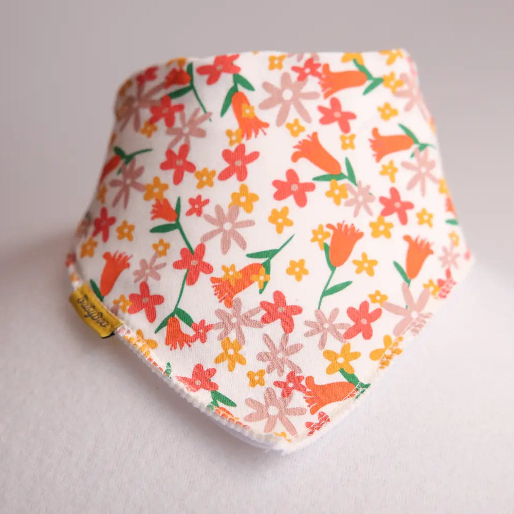 Floral patterned baby bib on a light gray background
