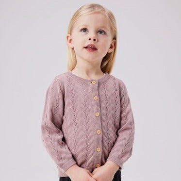 girl wearing rose coloured knit cardigan