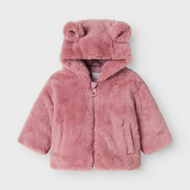 Pink fluffy jacket with hood on a light  background