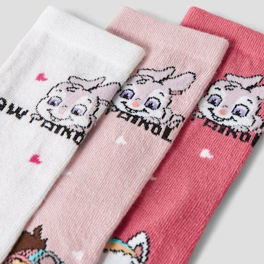 three different coloured pawpatrol socks in white, pale pink and bright pink with words and pictures of pawpatrol characters on them