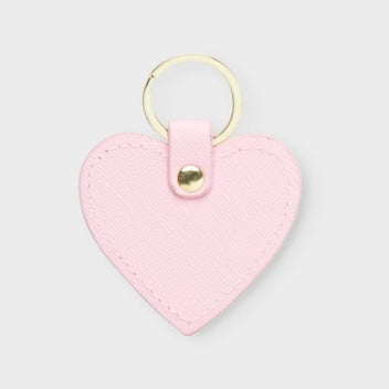 Pink heart-shaped keychain on a light grey background