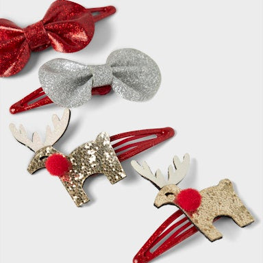 Set of festive hair accessories including reindeer-shaped clips and a bow on a white background