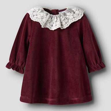 Maroon dress with white lace collar on a light  background