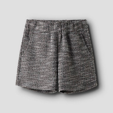 Black and white tweedy shorts on a light grey background