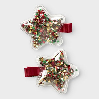 Two star-shaped hair clips with colorful sequins on a white background