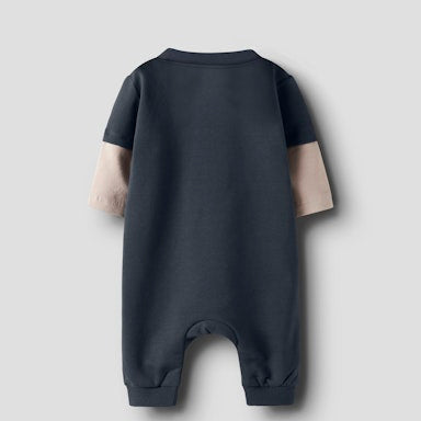 Black baby romper with beige accents on a light  background