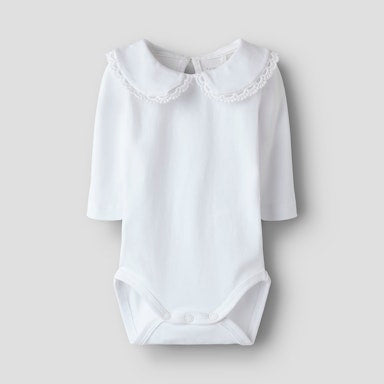 White baby bodysuit with lace collar on a light grey background