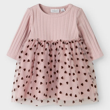 Pink dress with a sheer overlay featuring black heart patterns on a white background