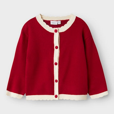 Red cardigan with white trim on a light  background