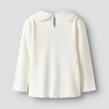 White ribbed blouse with a Peter Pan collar on a light  background