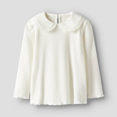 White blouse with a ruffled collar on a light  background
