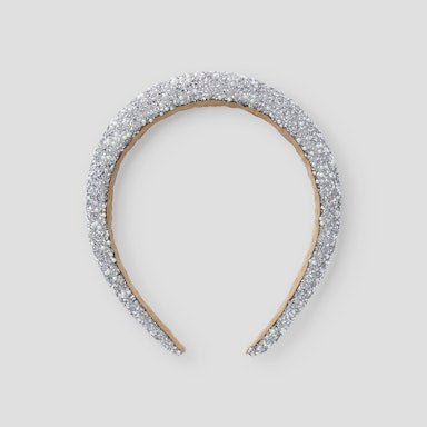 Silver headband with sparkling stones on a light  background