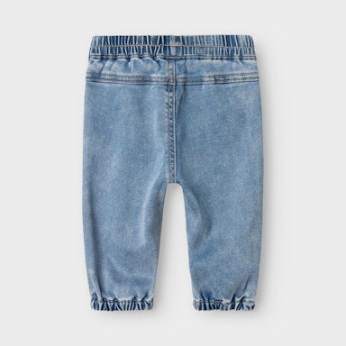 Light blue denim jogger pants on a white background