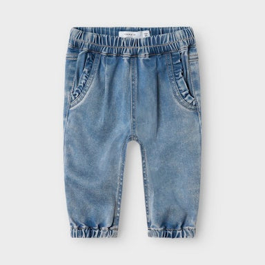Blue denim baby pants on a light  background