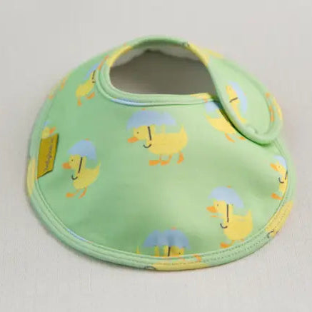 Green baby bib with yellow duck pattern on a light background