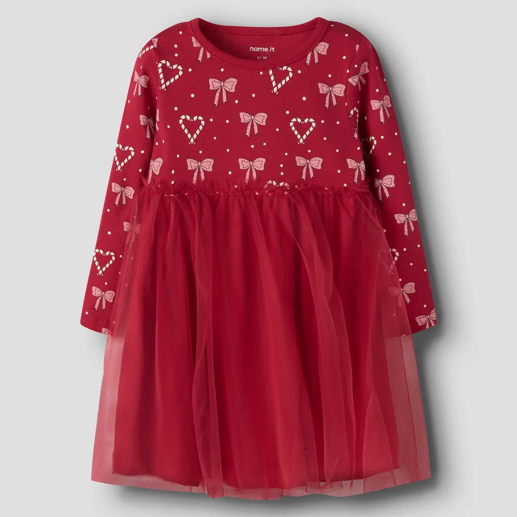 red dress with hearts and bow pattern on top and red tulle on bottom