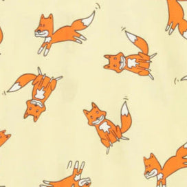 Baby onesie with fox pattern on a light background